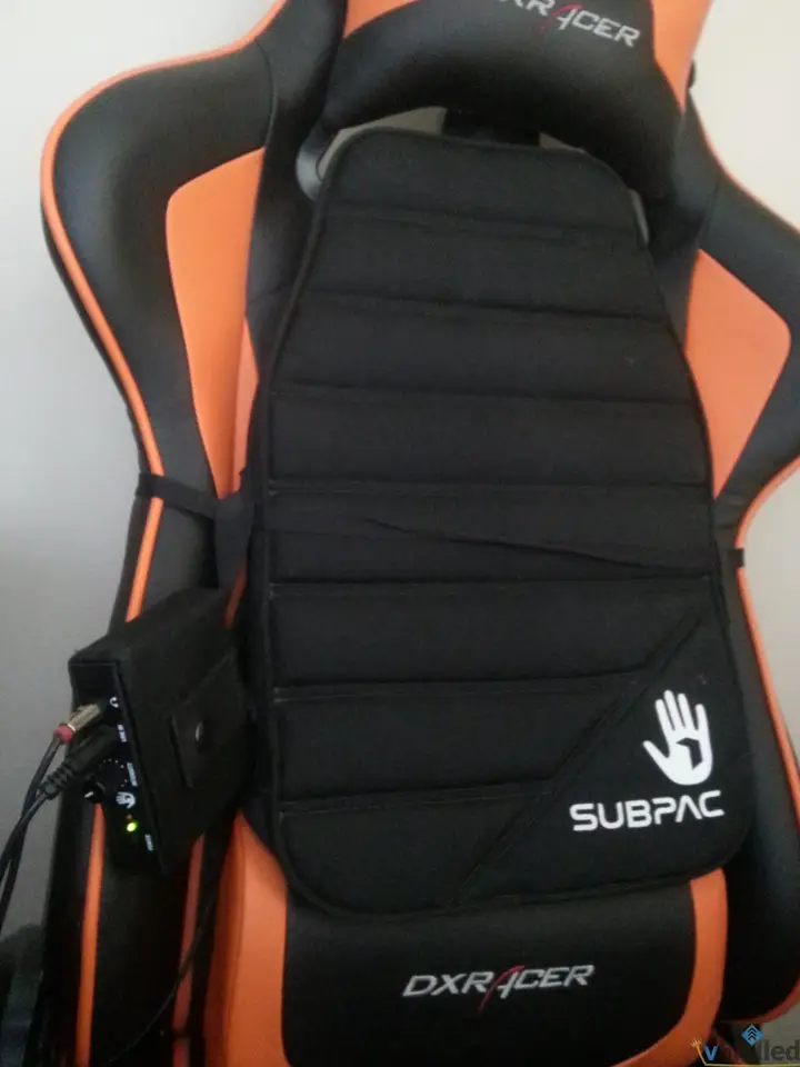 SubPac S1 cushion fitted between the DXRacer chair back and headrest
