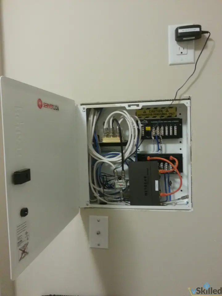 Open home network wiring cabinet mounted in the laundry room
