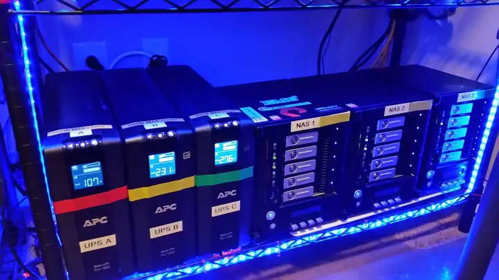 Three UPS batteries and three NAS units labeled by power feed