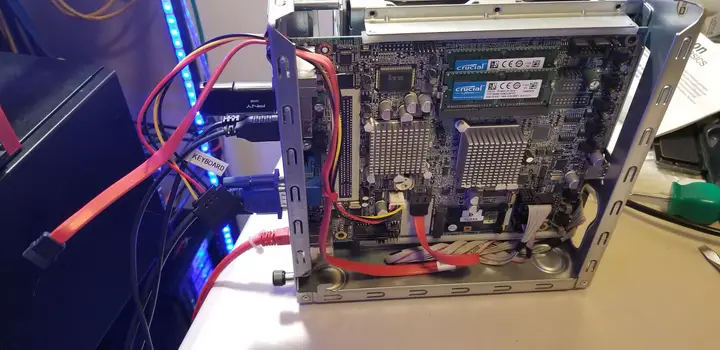 Open Thecus N5550 with added SATA data and power cables connected to its motherboard