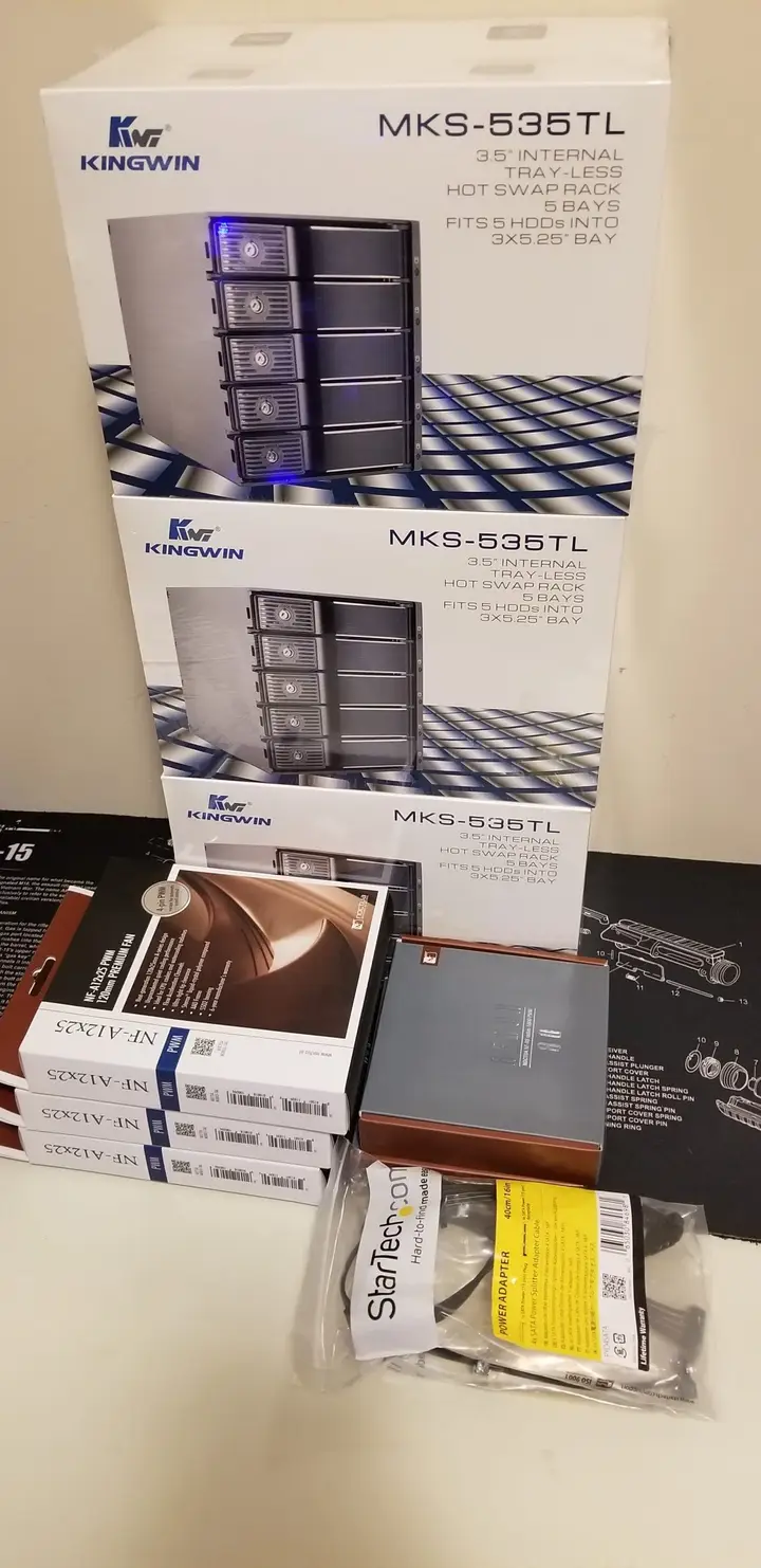 Boxed KingWin drive cages and cooling components for the Zion server build