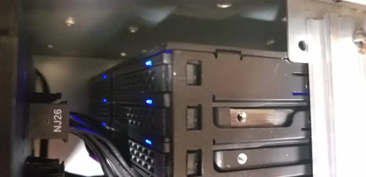 Front of the internal six-bay SSD cage with blue activity lights