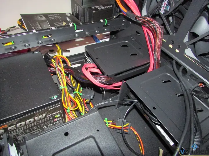 Drive bays and bundled power and SATA cables inside the server case