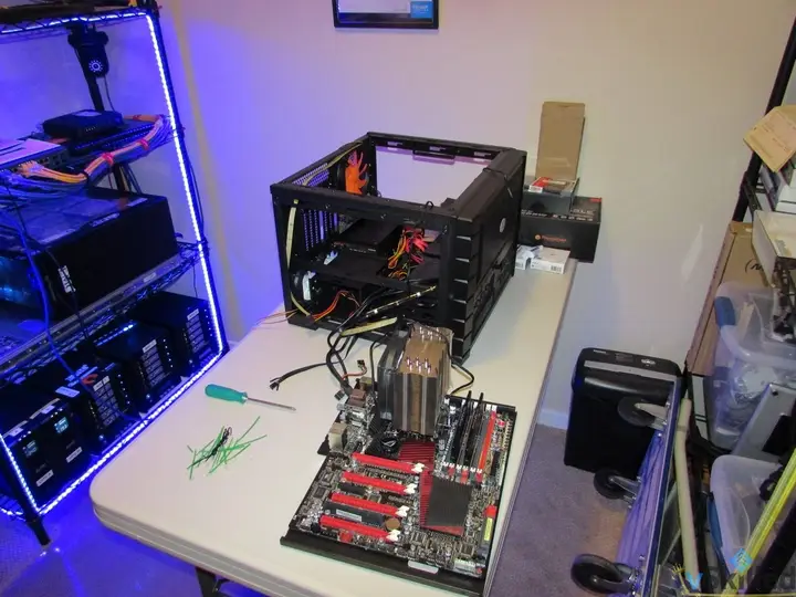Motherboard and tower CPU cooler beside the open server chassis