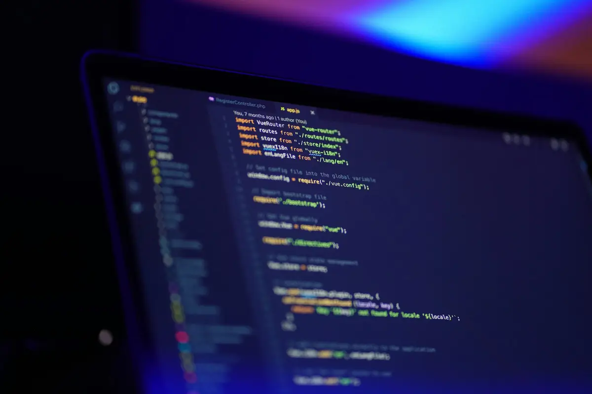 Laptop screen with a code editor in blue light