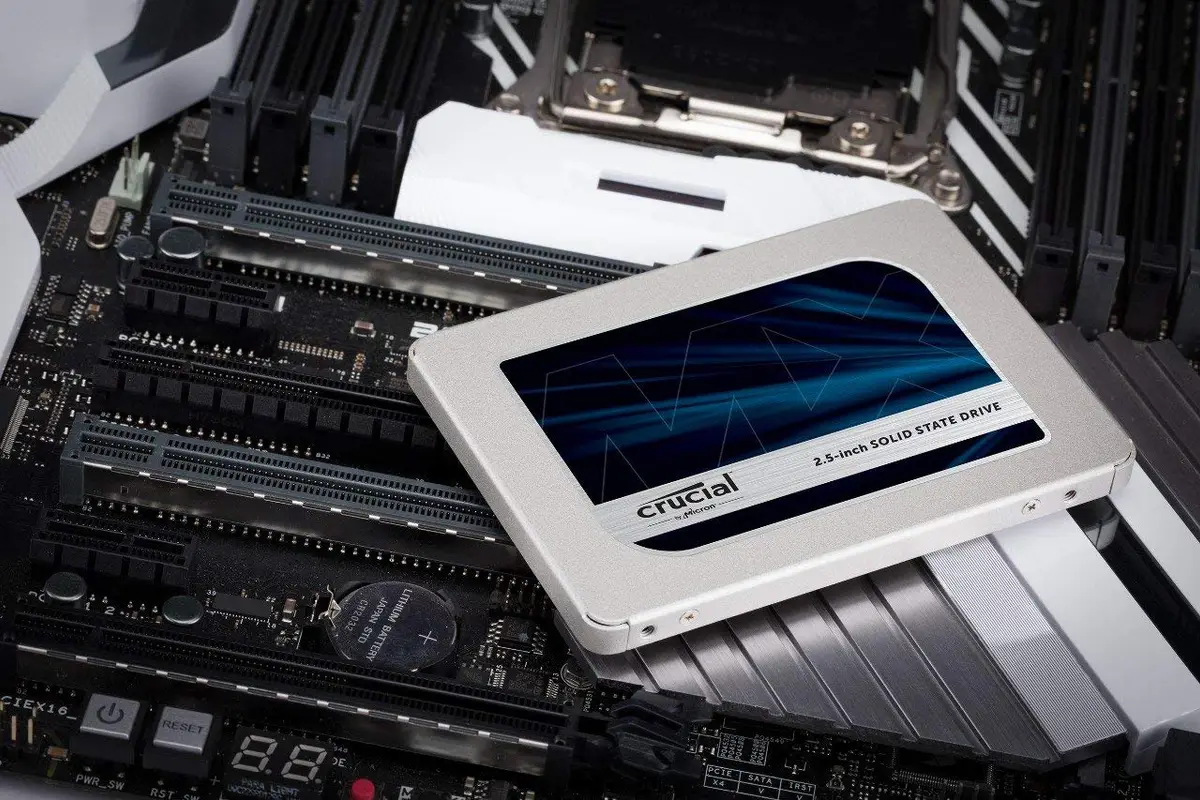 Crucial 2.5-inch solid-state drive resting on a motherboard