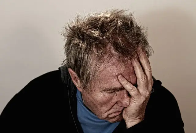 Person resting their face in one hand