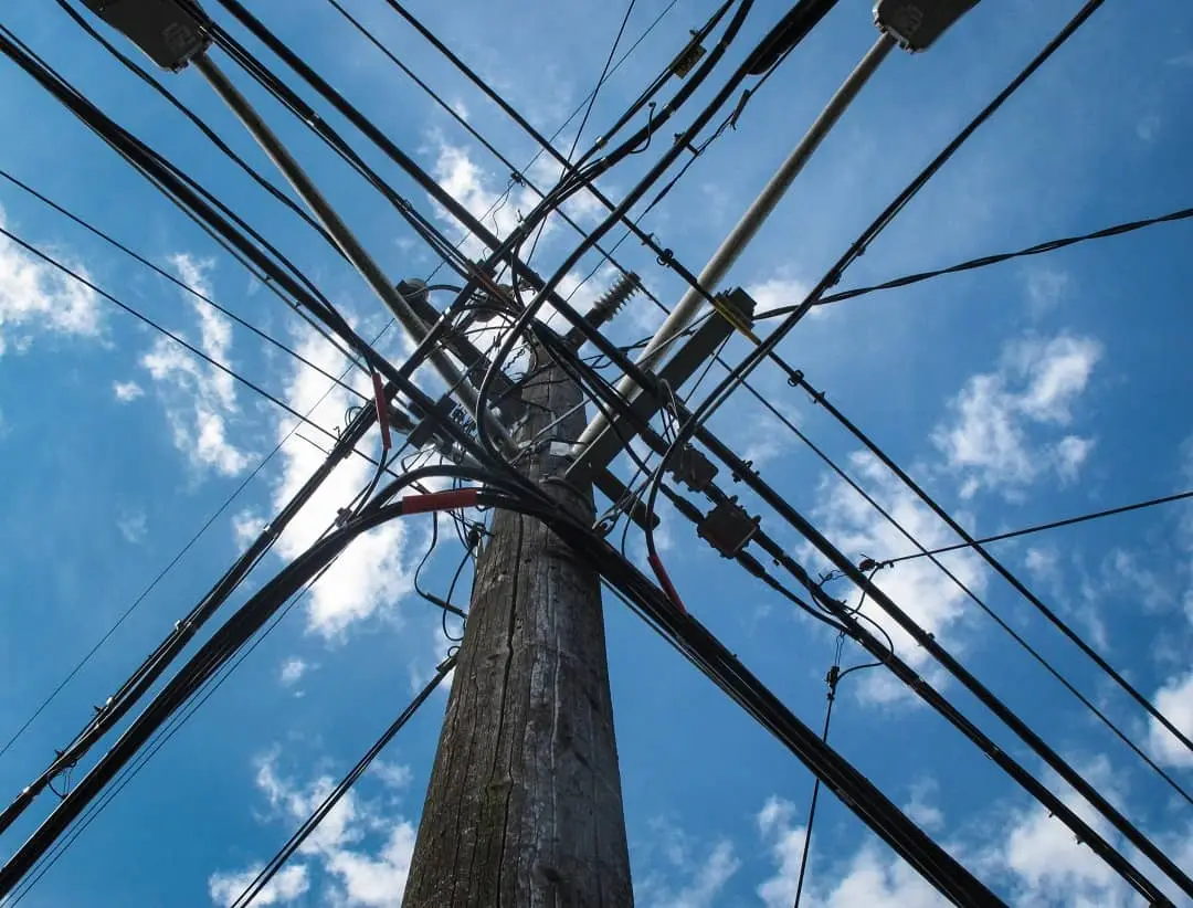 Utility pole with overhead power and communication lines