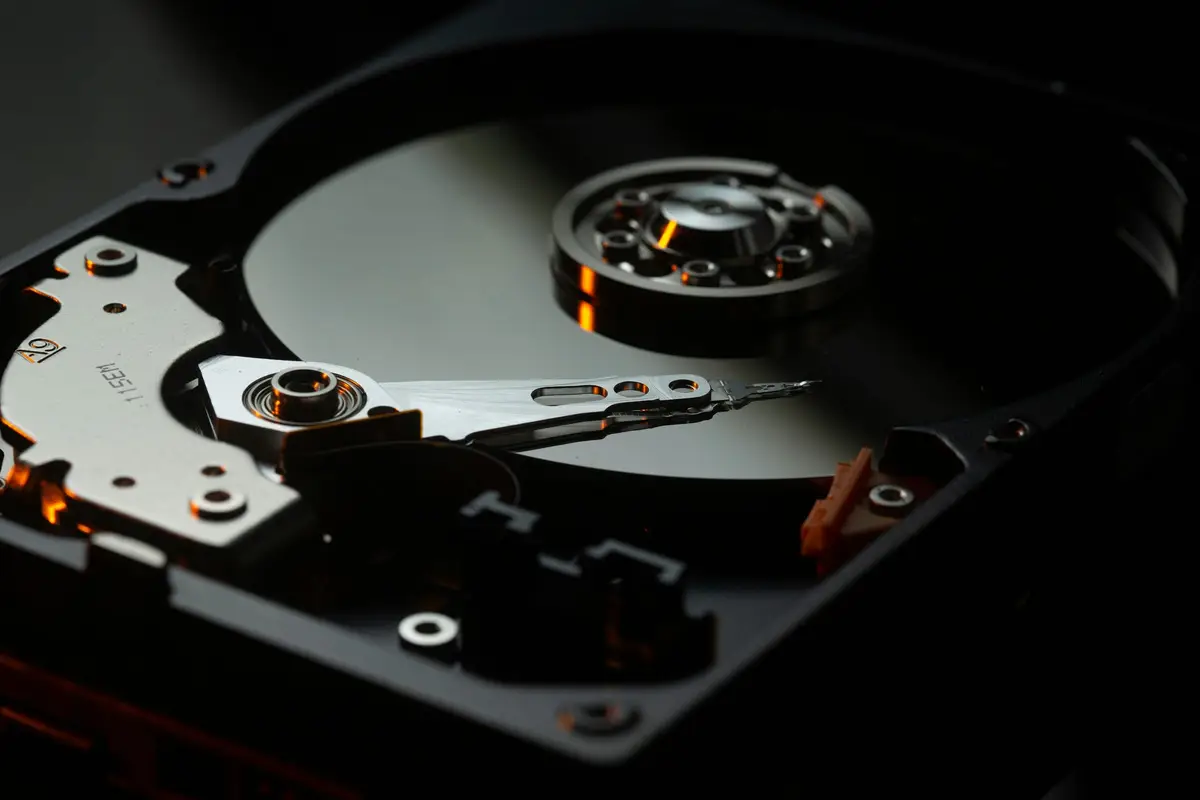 Exposed hard-drive platter and actuator arm in low light