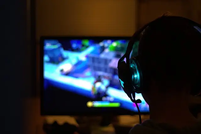 Person wearing a headset while playing a video game