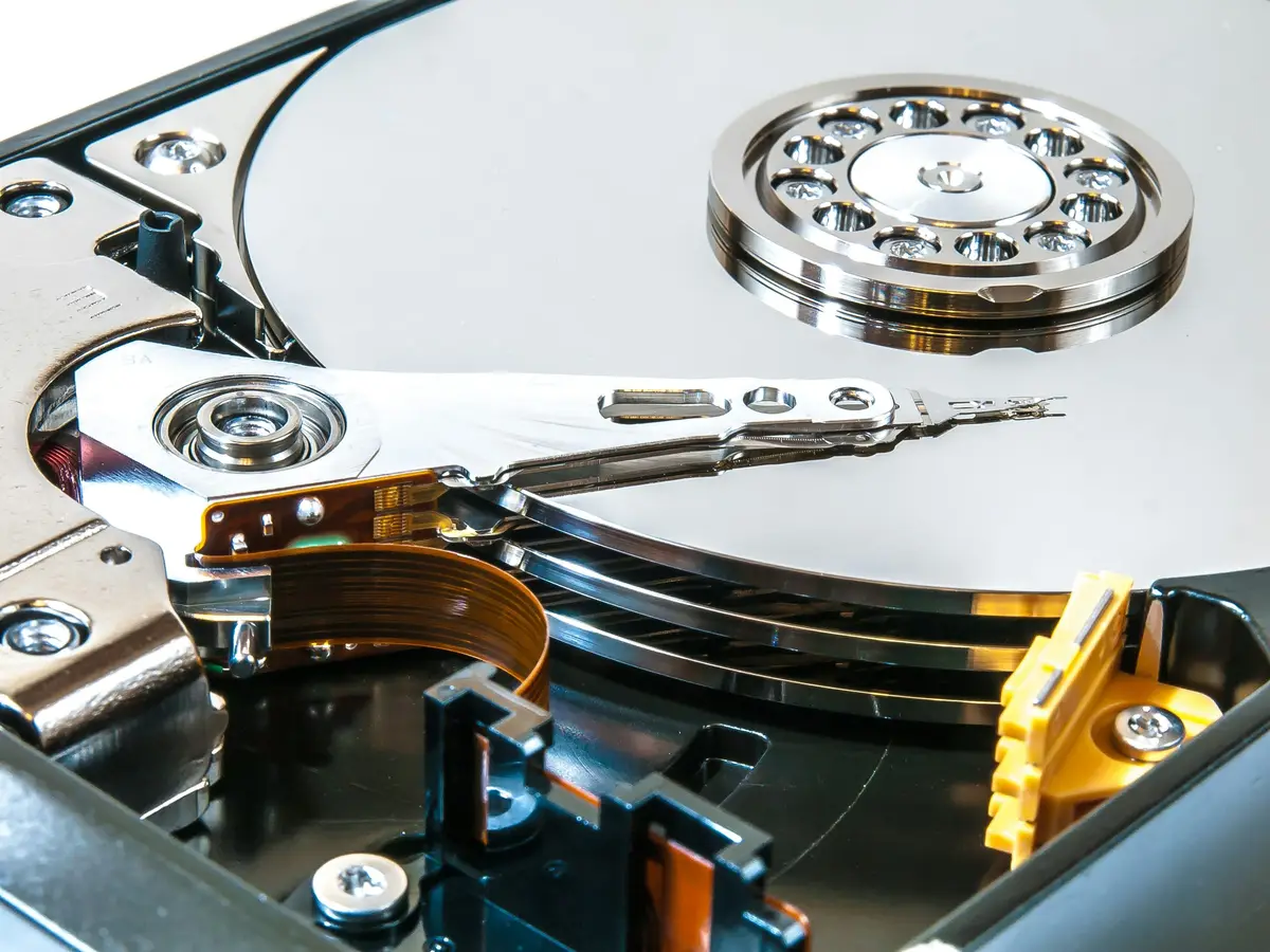 Close view of the platter and read-write arm of an open hard drive