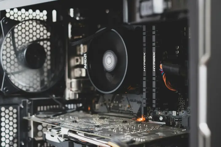 Open desktop computer case with a cooling fan and expansion cards
