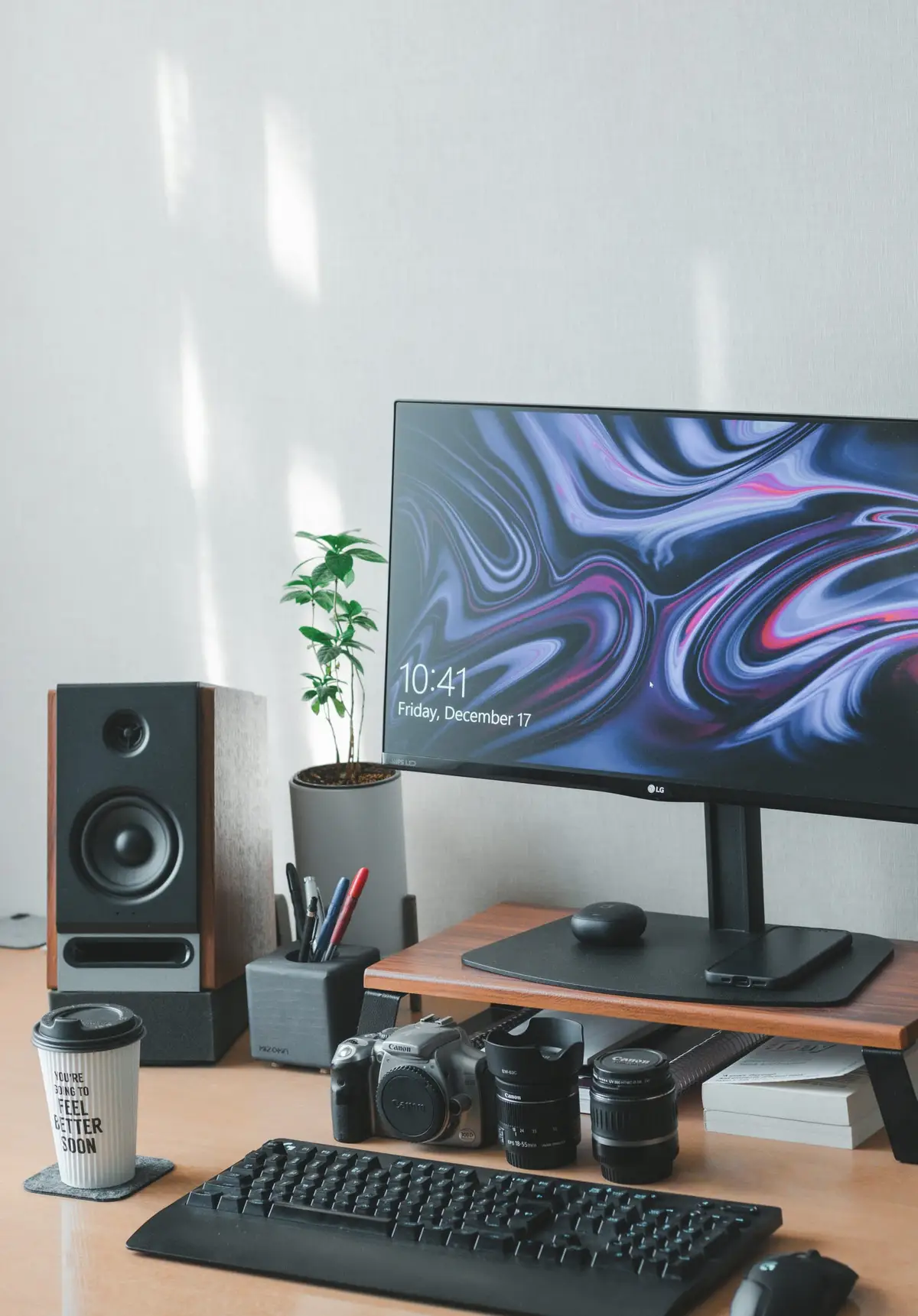 Desktop monitor, keyboard and speakers on a wooden desk