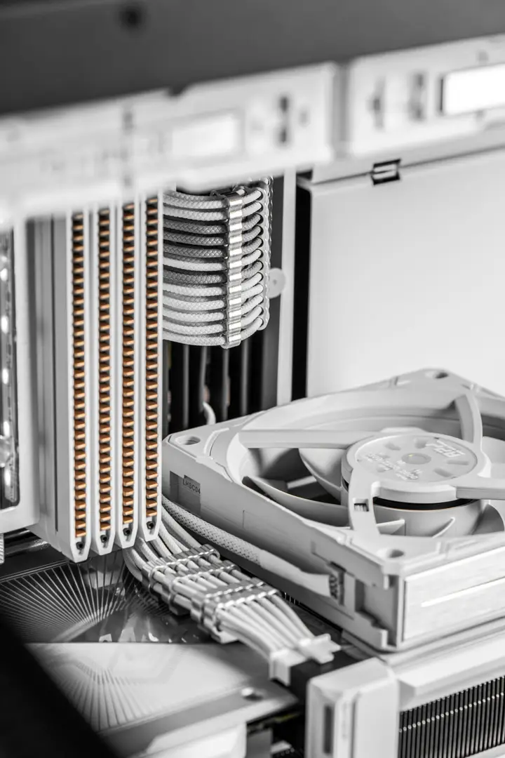 Tower CPU cooler and fan beside neatly routed white cables