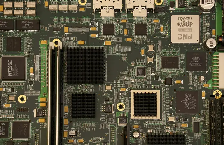 Green computer motherboard with expansion slots and processor sockets