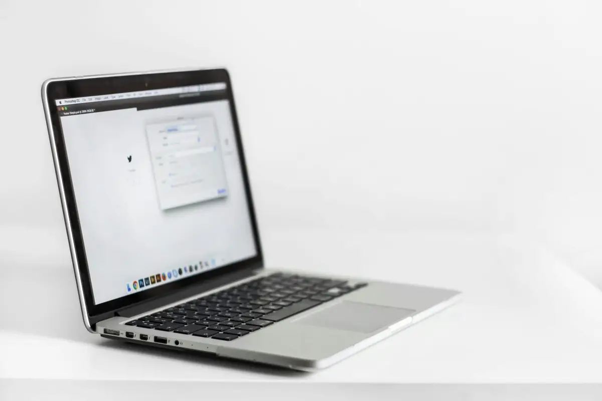 Open laptop on a white desk displaying a browser window