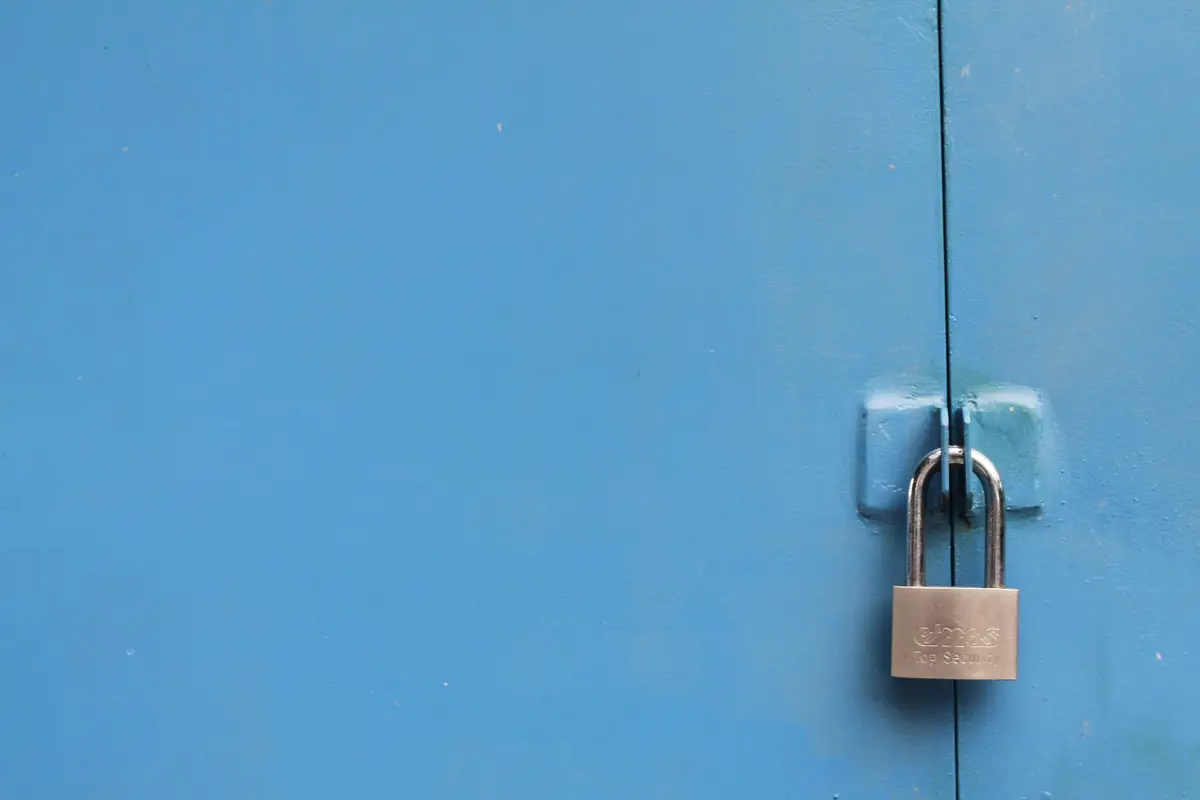 Closed blue cabinet doors secured with a padlock